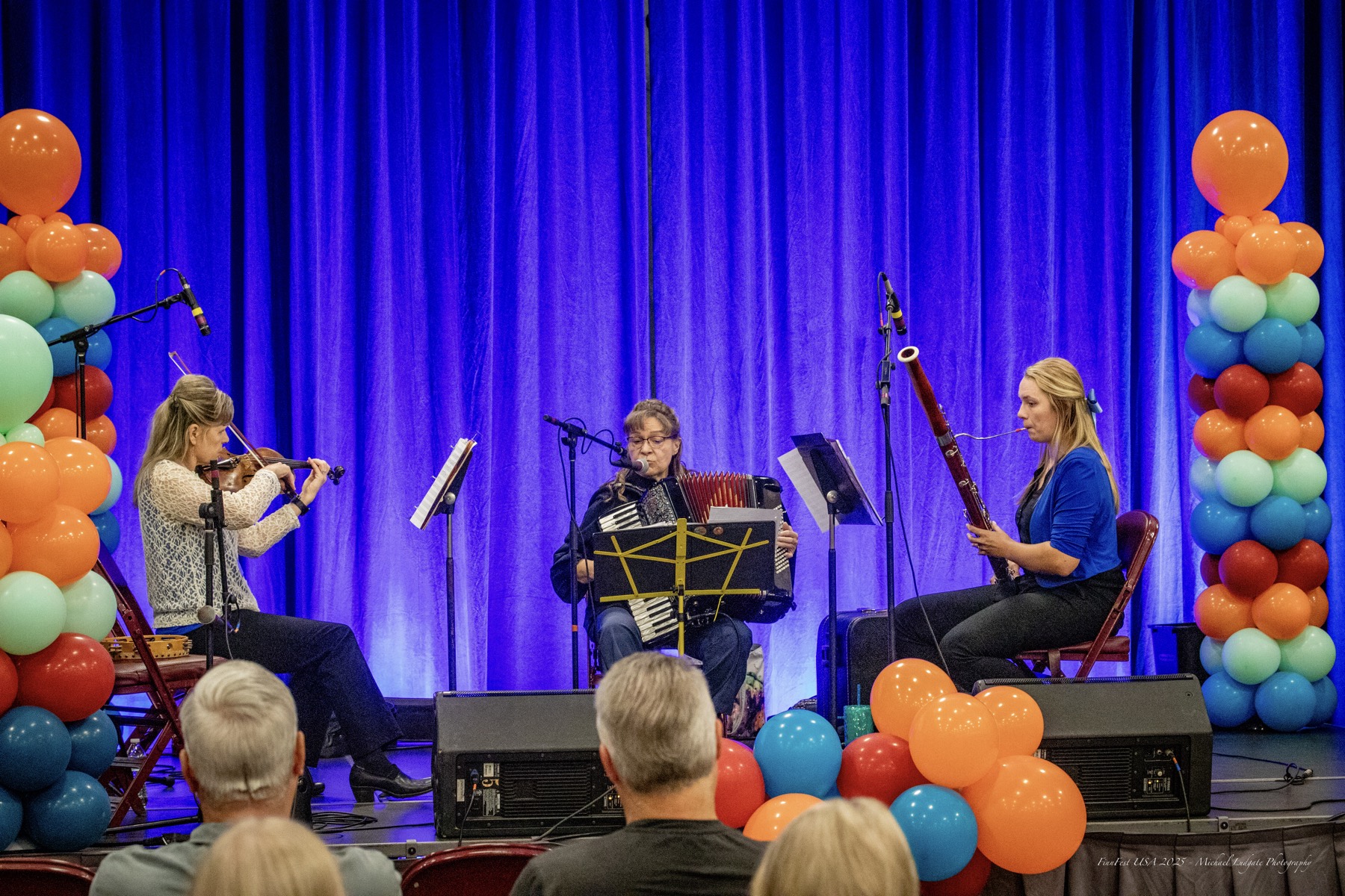 Northern Stars Sámi Girls performing on stage: violin, accordion, and bassoon