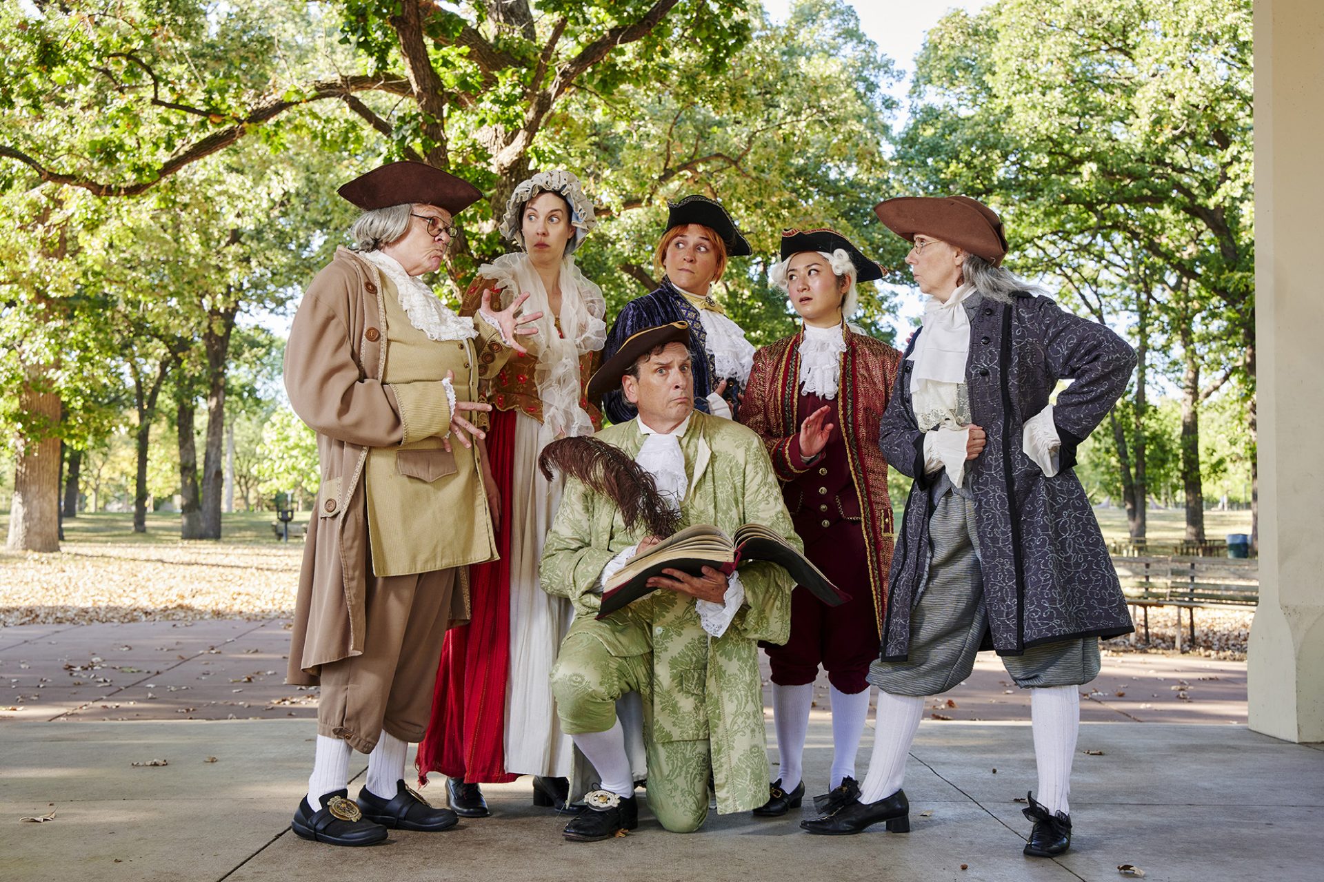 MORTON cast in Revolutionary-era costumes posing under trees at Minnehaha Park