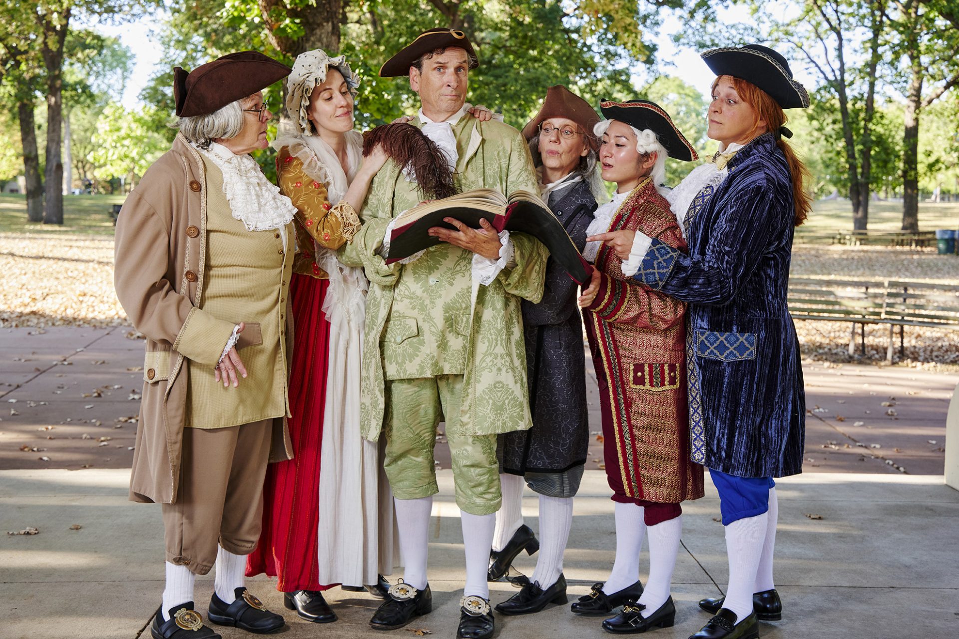 MORTON cast of six in 18th-century costumes with the central actor holding a book